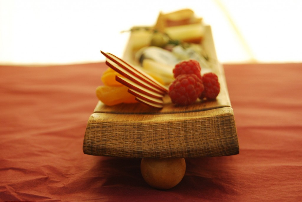 Food plated on a wooden board. Good to look at, awkward to eat off